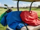 Golf cart seat covers being installed on a sunny day at a golf course, with colorful options nearby.